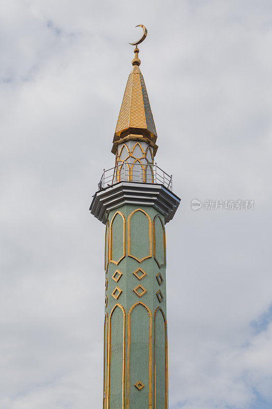 View of traditional mosque minaret tower, distinctive architectural feature of mosques. Traditional and typical mosque architectural details.